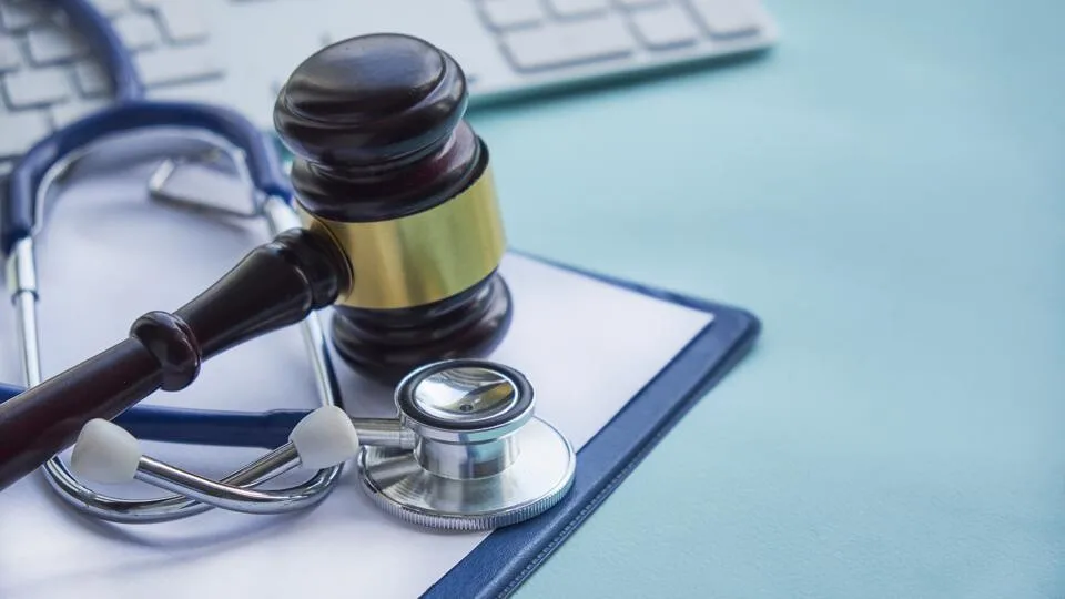 Gavel and stethoscope on desk symbolizing medical law on mk677.