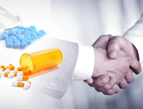 Pharmaceutical industry - enclomiphene collaboration in UK, handshake overlapping with pills and container.