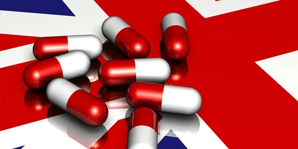UK flag background with enclomiphene capsules, representing British pharmaceutical research and development.